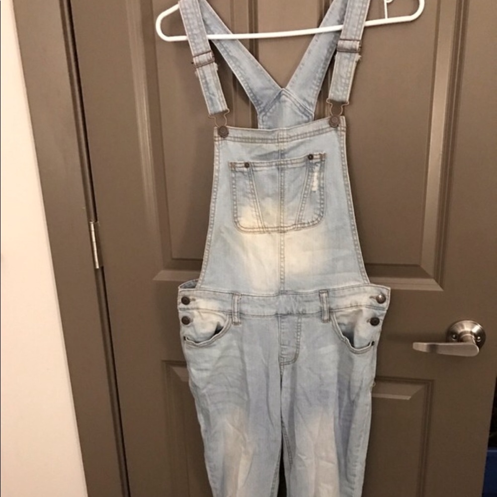 Light-wash distressed denim overalls